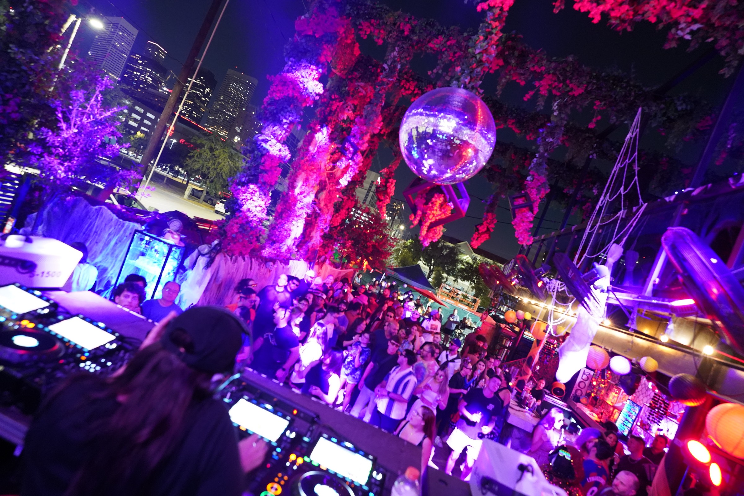 A DJ playing to a crowd under a mirror ball at a DRIFT night
